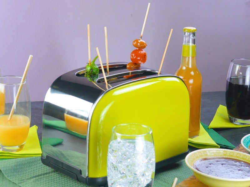 Partyspieße in einem grünen Toaster steckend