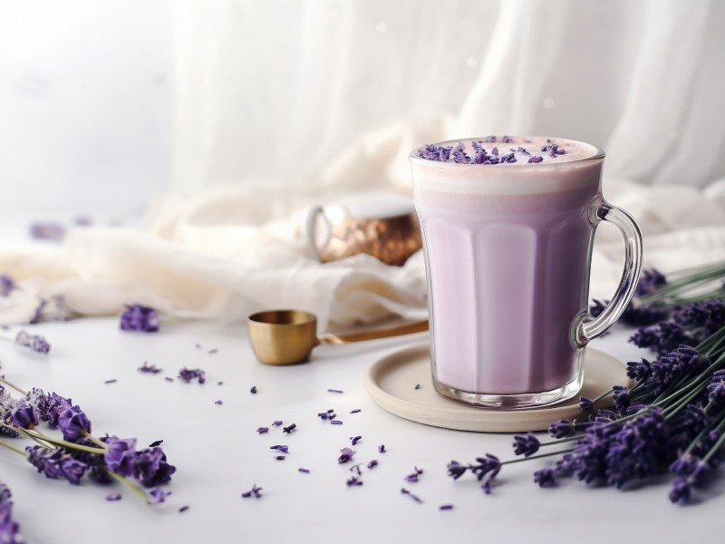 Tasse mit lilafarbenem Getränk und getrocknetem Lavendel