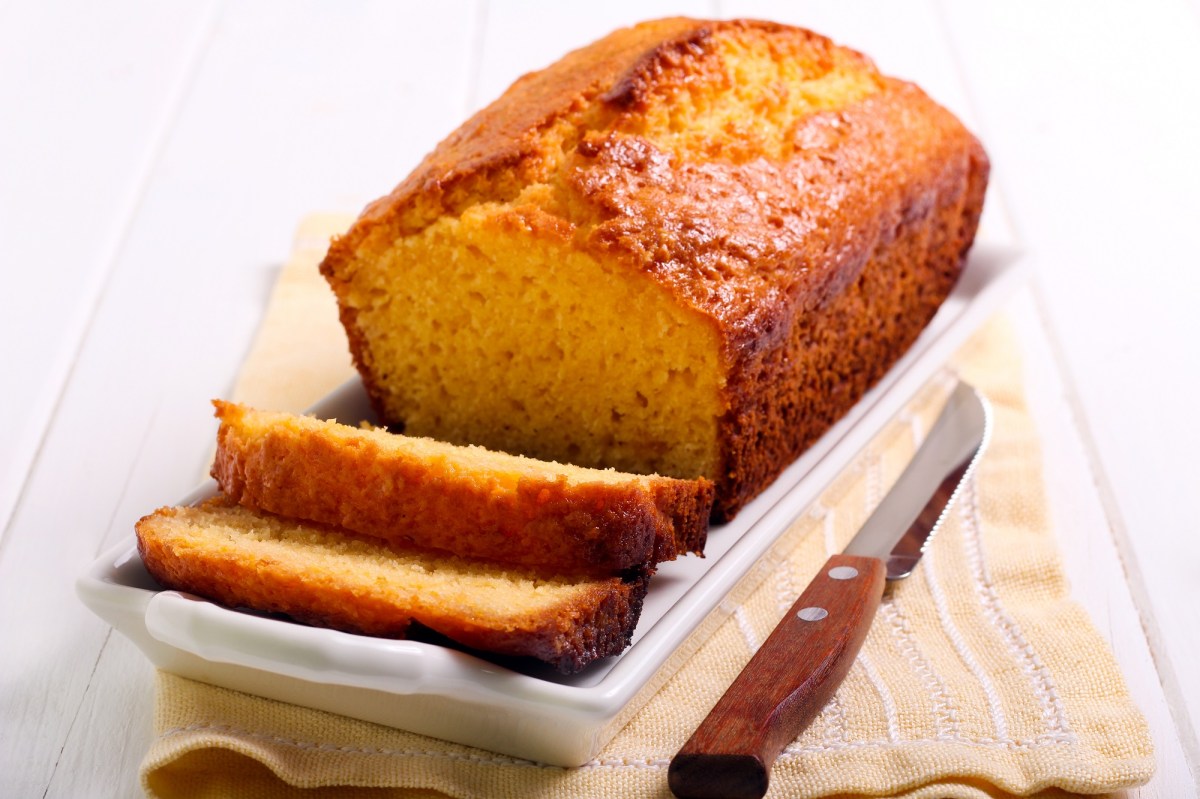 Angeschnittener Polenta-Kuchen mit Grapefruit auf einem weißen Servierteller