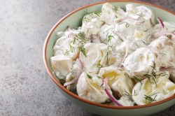 Eine Schale Schwedischer Kartoffelsalat mit roten Zwiebeln, Nahaufnahme