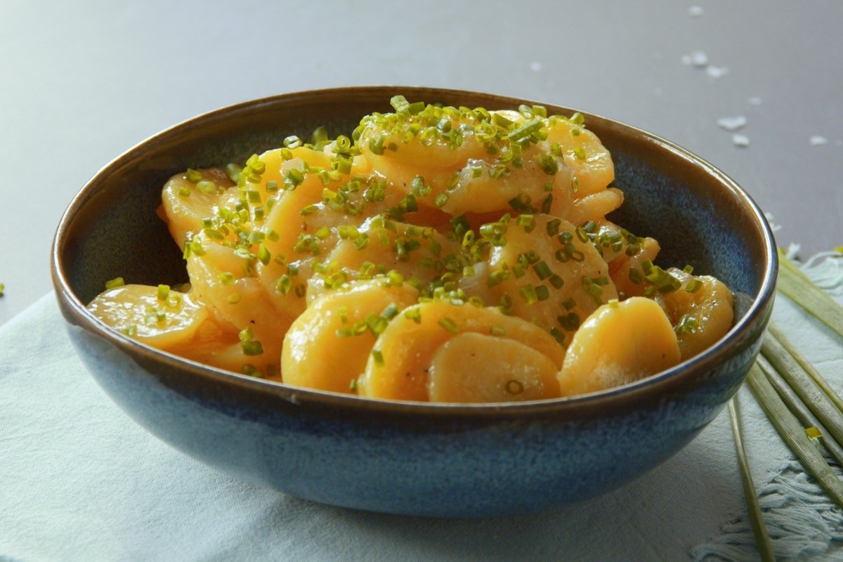 Eine Schale Kartoffelsalat mit Essig und Öl.