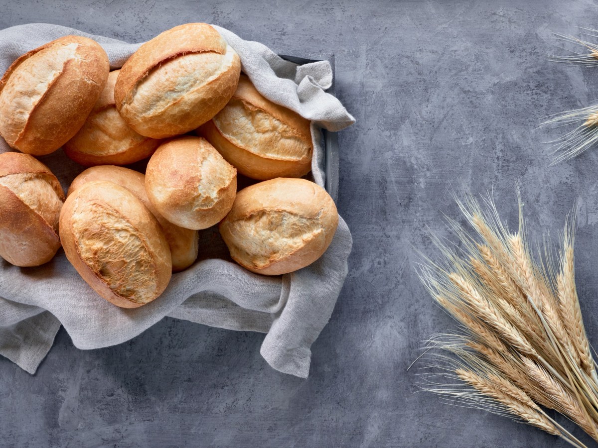 Brötchen ohne Kneten: Ein Korb Brötchen, daneben Weizenähren